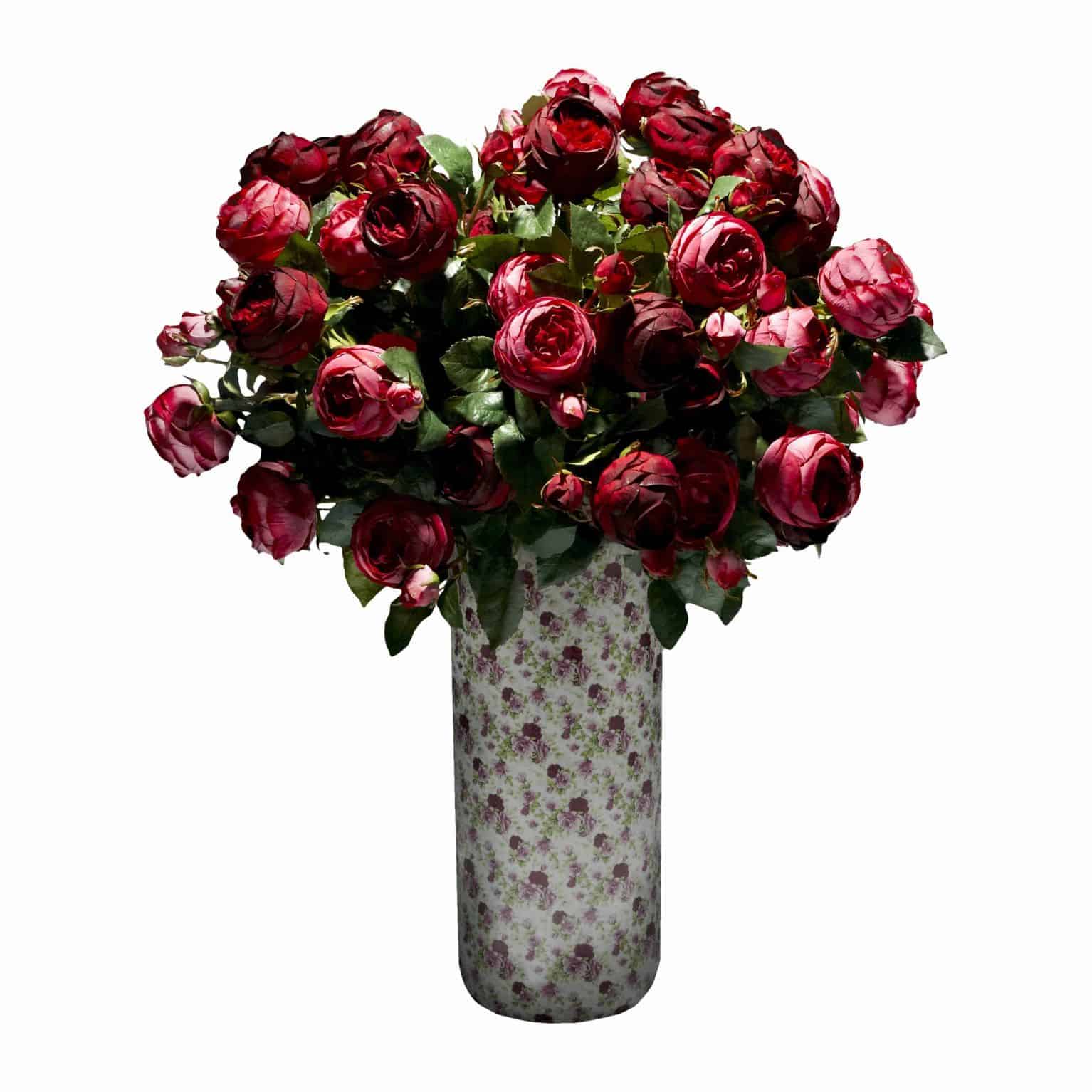 Buy now and take the one you loves breath away with our lavish wine and ruby port silk rose artificial flower arrangement in a rose printed vase.