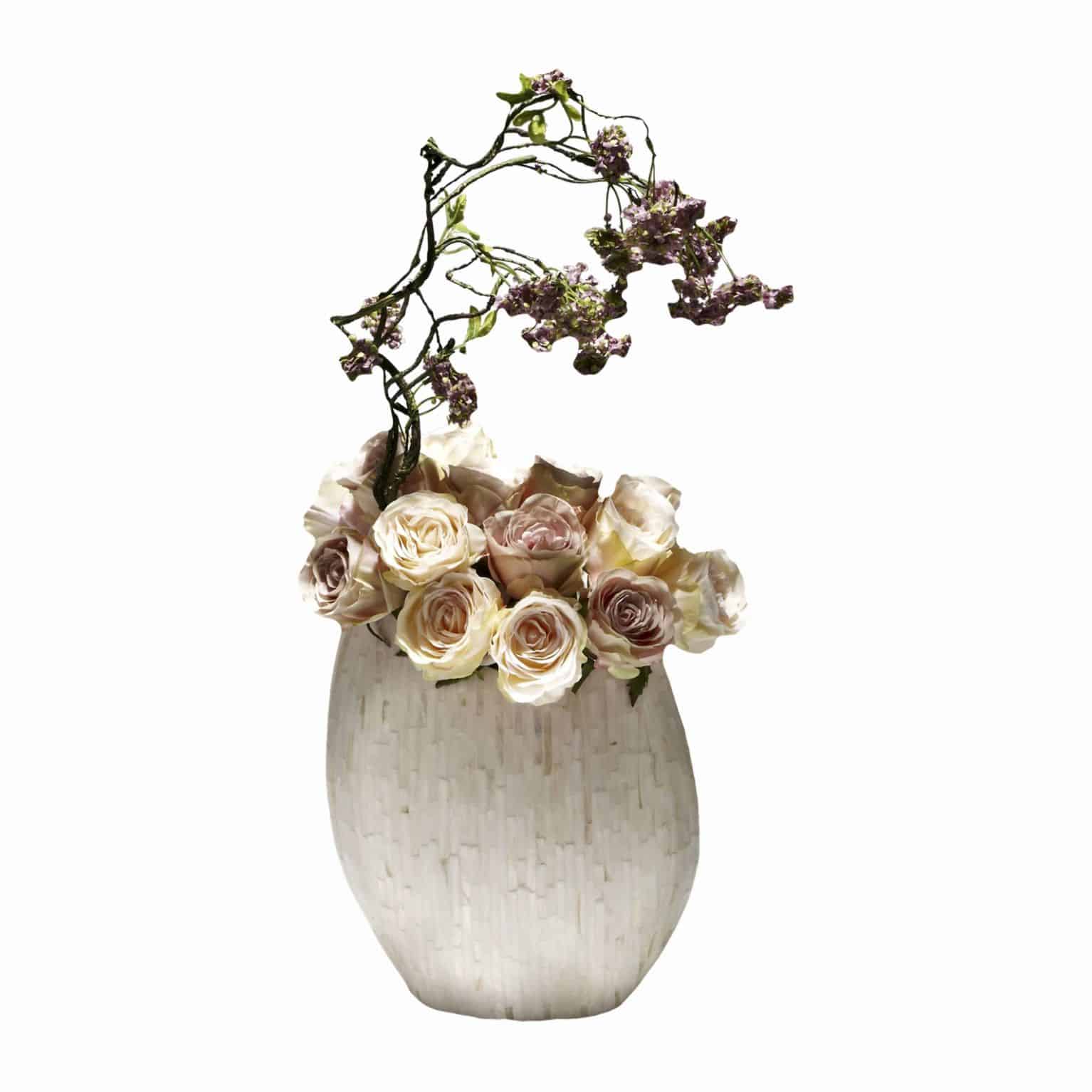 Buy and enjoy garden and woodland in this harmonious arrangement. Peach and Lilac artificial silk flower roses with falling soft purple snowball branches.