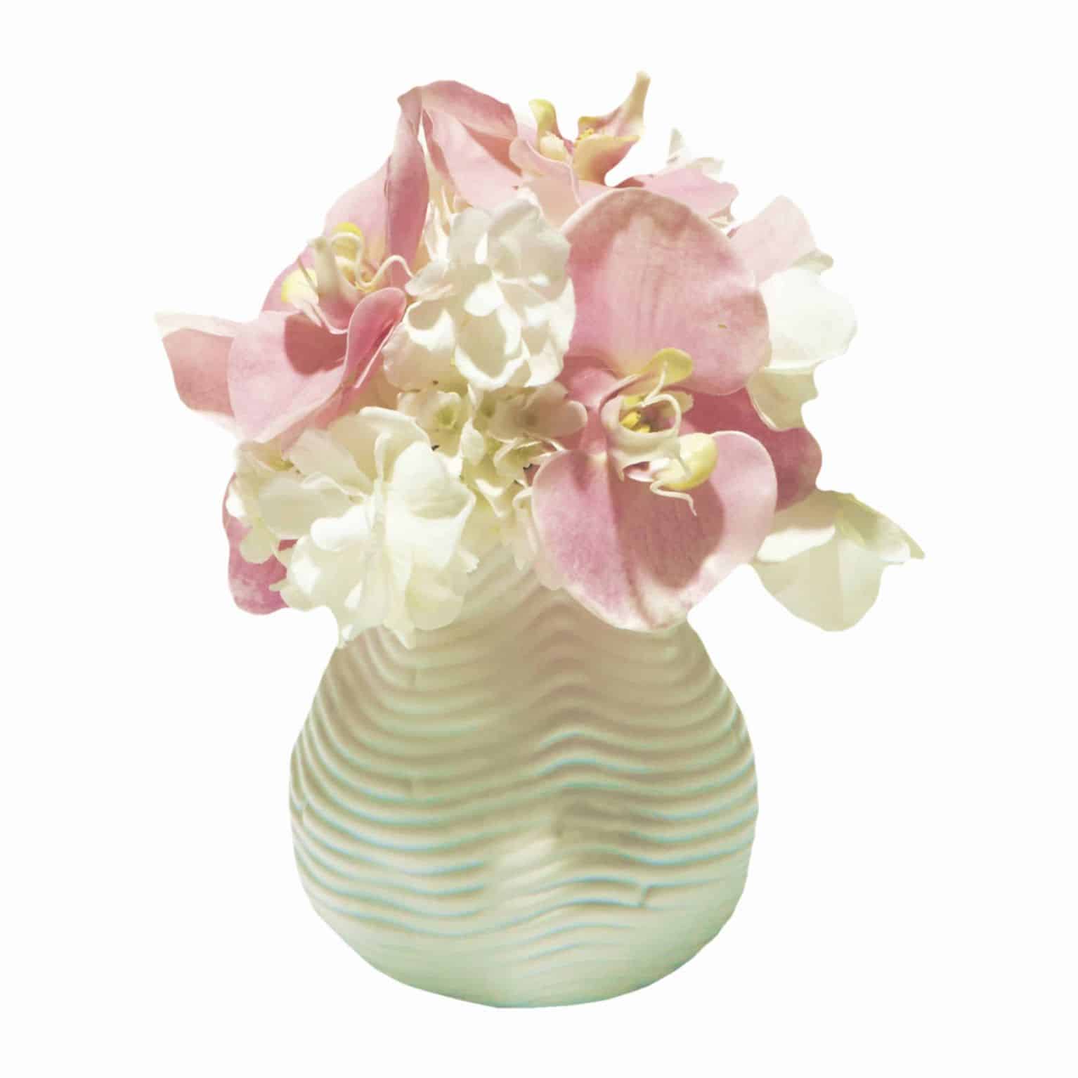 Buy our sweet little vase arrangement of glowing silk white butterfly hydrangea flowers and pretty pink phalaenopsis orchid artificial flowers.